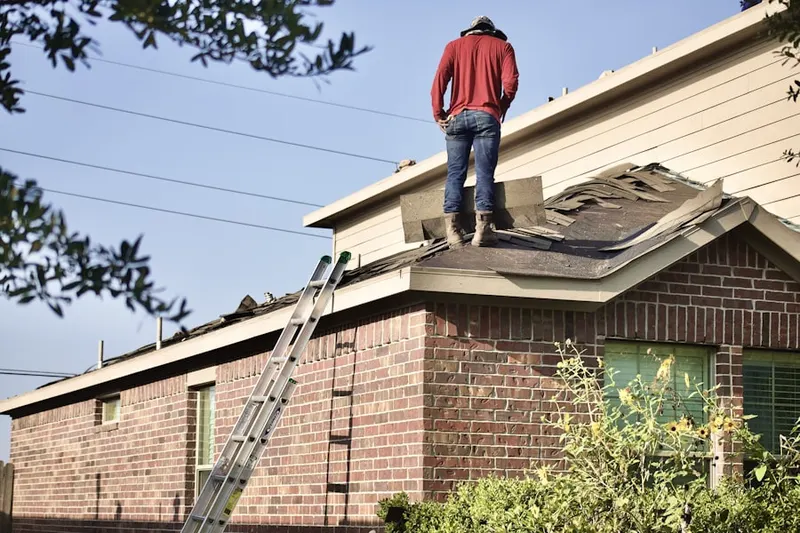 Professional roofer working on a residential roof in Moraine